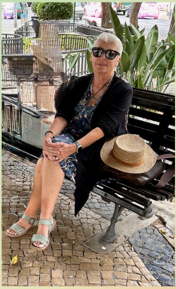 Ali Heathfield sitting on a bench in Portugal